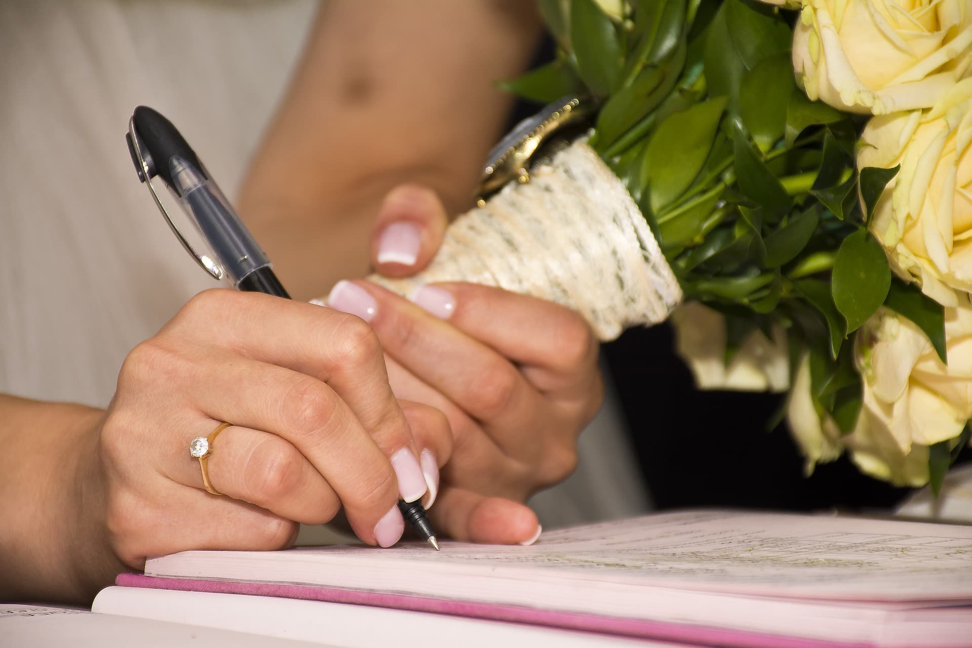 Bride signing prenup before wedding.